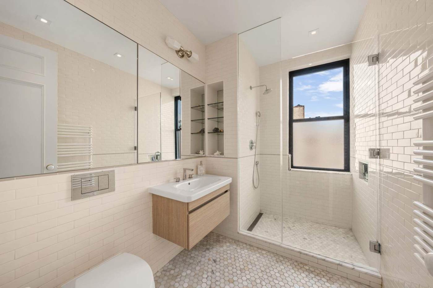 Tiled bathroom with a glass shower enclosure